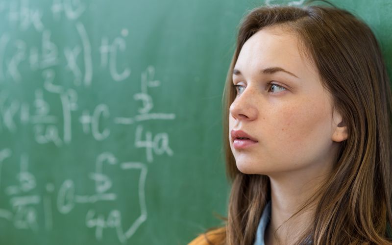 girl in front of board